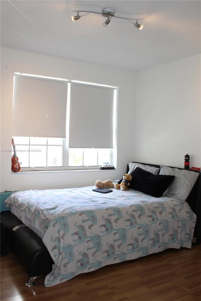 bedroom with wood finished floors