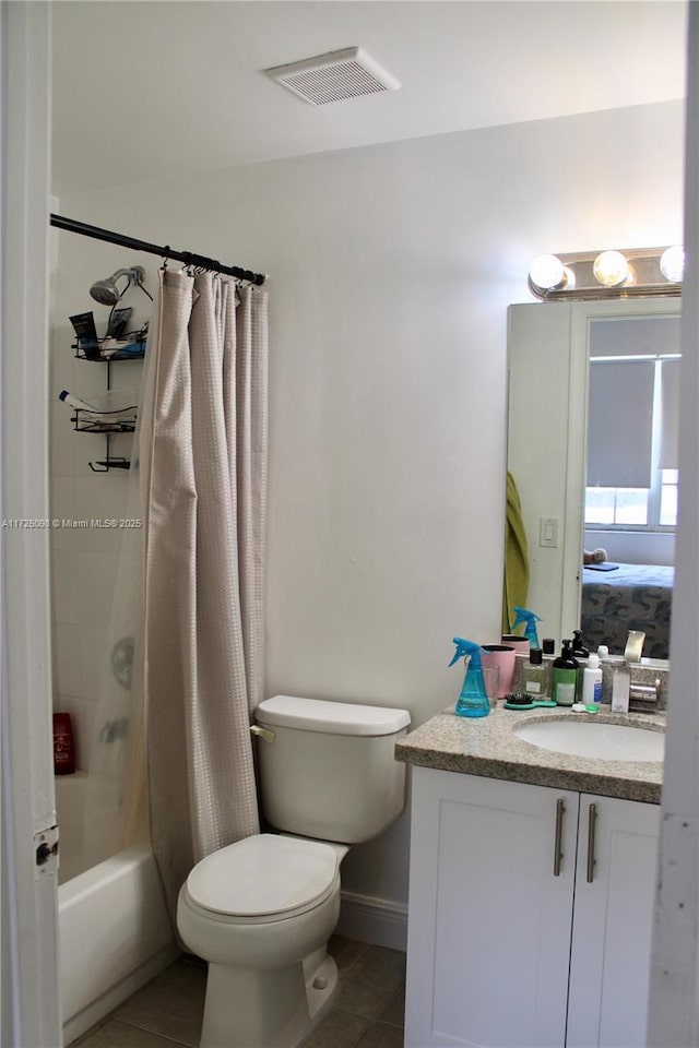 full bath with shower / bath combo, visible vents, toilet, vanity, and tile patterned floors