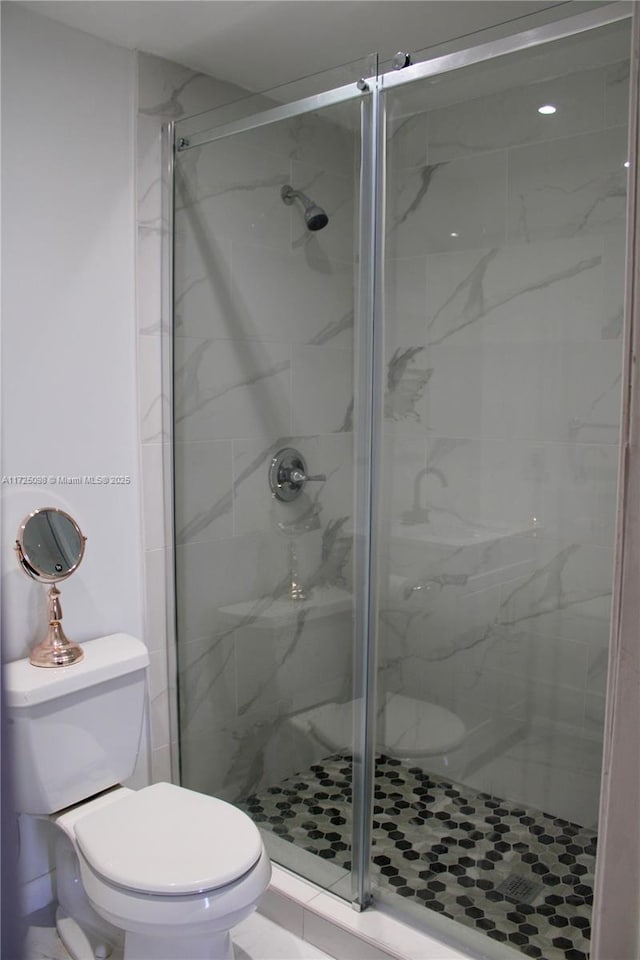 full bathroom with toilet and a stall shower