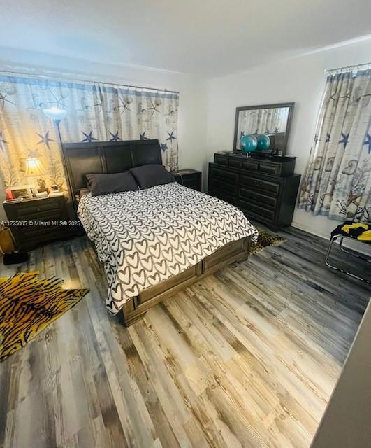 bedroom with wood-type flooring