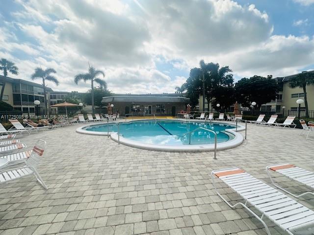 4441 NW 16th St Unit J311, Lauderhill, FL 33313 - community pool with a patio