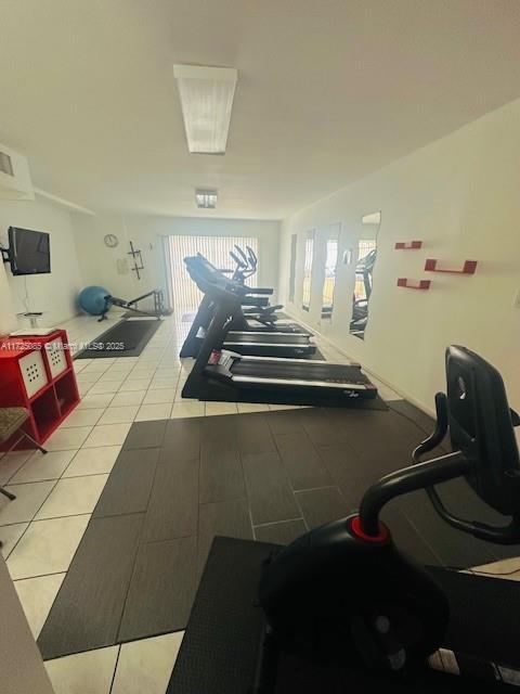 exercise room with tile patterned flooring