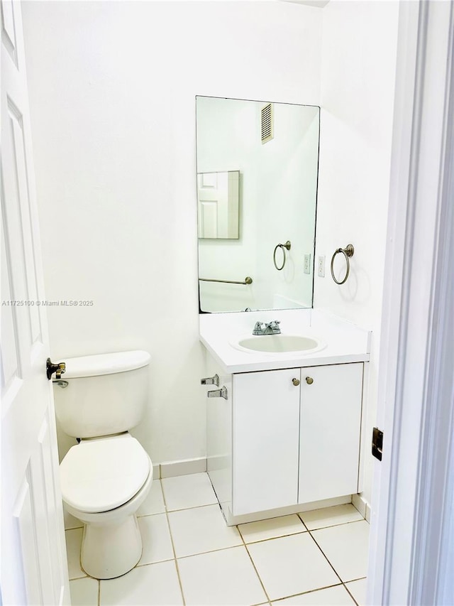 bathroom with tile patterned floors, vanity, and toilet