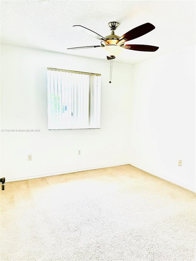 empty room featuring ceiling fan and a textured ceiling