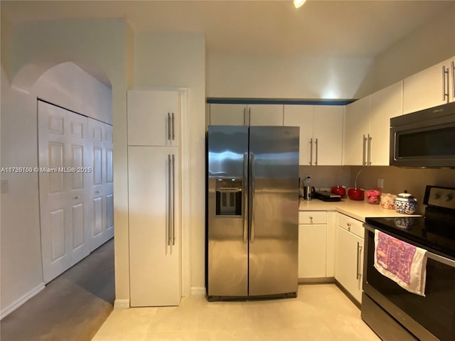 kitchen with appliances with stainless steel finishes and white cabinetry