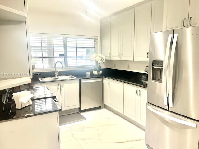 kitchen featuring white cabinets, sink, and appliances with stainless steel finishes