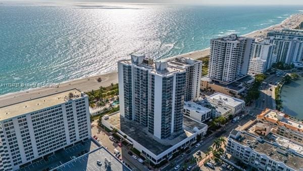 drone / aerial view featuring a water view and a view of the beach