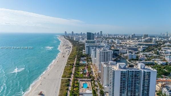 bird's eye view featuring a view of the beach and a water view