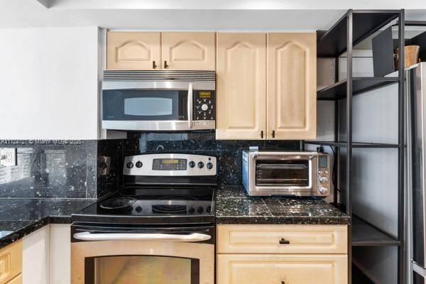 kitchen featuring light brown cabinetry and stainless steel appliances