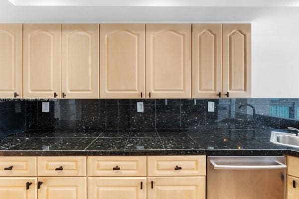 kitchen with dishwasher, light brown cabinets, and decorative backsplash