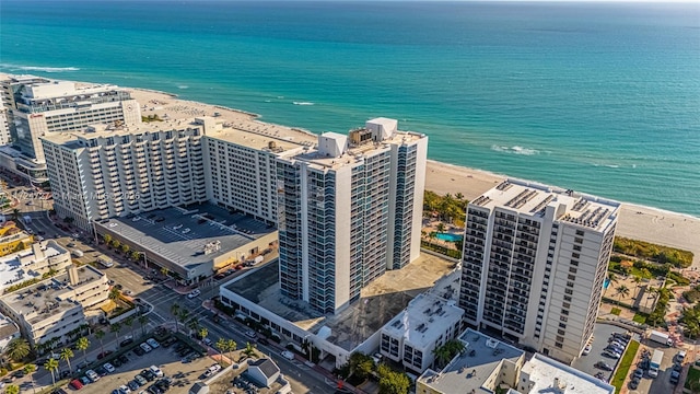 birds eye view of property with a water view and a view of the beach