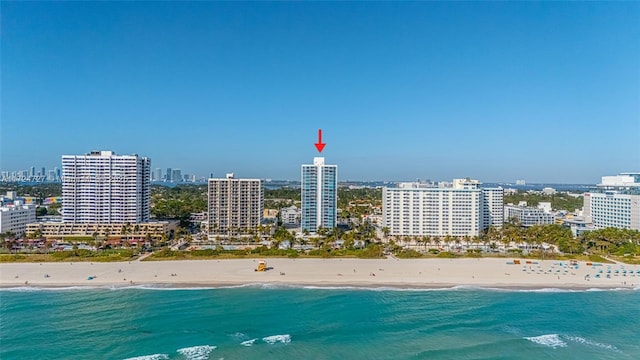 drone / aerial view featuring a water view and a beach view