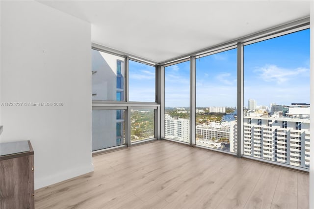 interior space featuring light hardwood / wood-style flooring and floor to ceiling windows