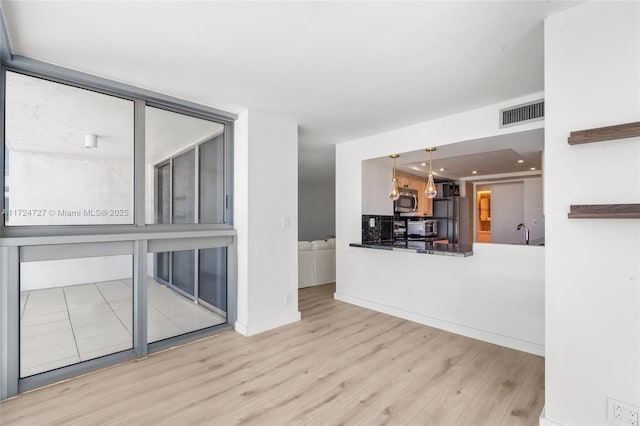 unfurnished living room featuring light hardwood / wood-style flooring