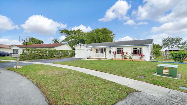 ranch-style house featuring a front yard and a garage