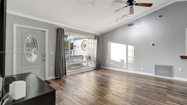 foyer featuring ceiling fan, ornamental molding, hardwood / wood-style flooring, a textured ceiling, and lofted ceiling