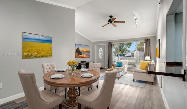 dining space with lofted ceiling, ceiling fan, ornamental molding, and wood-type flooring