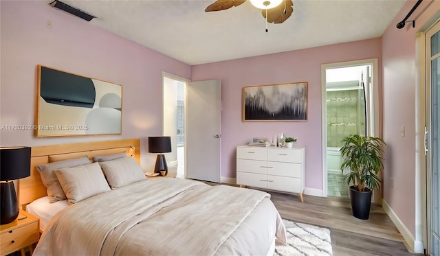 bedroom with ceiling fan, light hardwood / wood-style floors, and connected bathroom