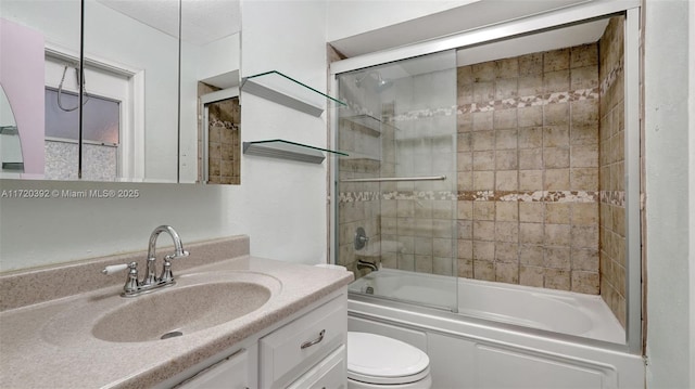 full bathroom featuring shower / bath combination with glass door, vanity, and toilet