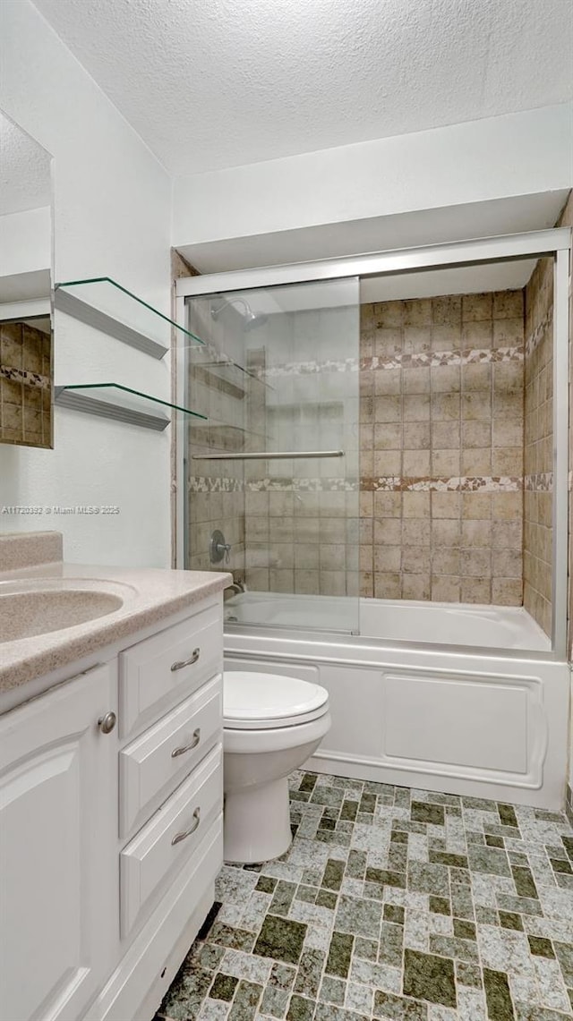 full bathroom featuring a textured ceiling, enclosed tub / shower combo, vanity, and toilet