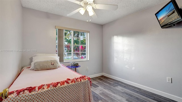 bedroom featuring ceiling fan, a textured ceiling, and wood-type flooring