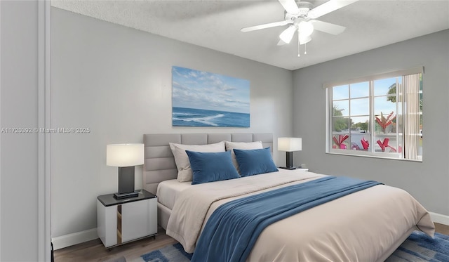 bedroom with ceiling fan and hardwood / wood-style floors