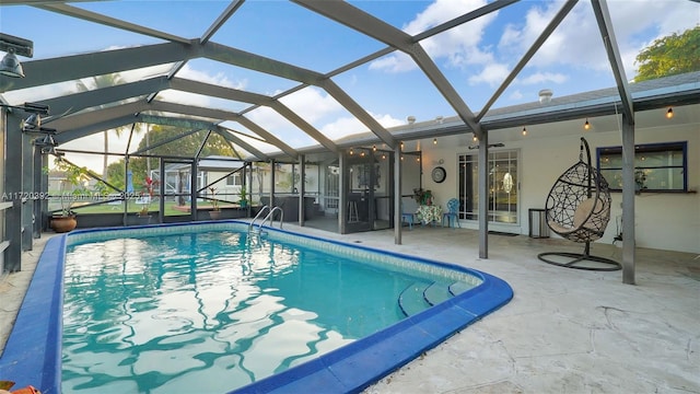 view of pool featuring glass enclosure and a patio area