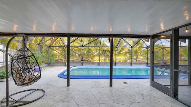 view of swimming pool with a lanai and a patio area