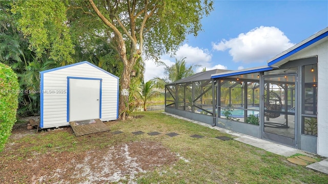 view of yard with a lanai and a storage shed