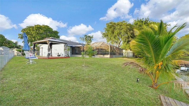 view of yard with a gazebo and glass enclosure