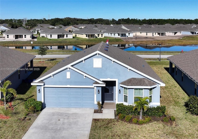 exterior space with a front lawn, a water view, and a garage