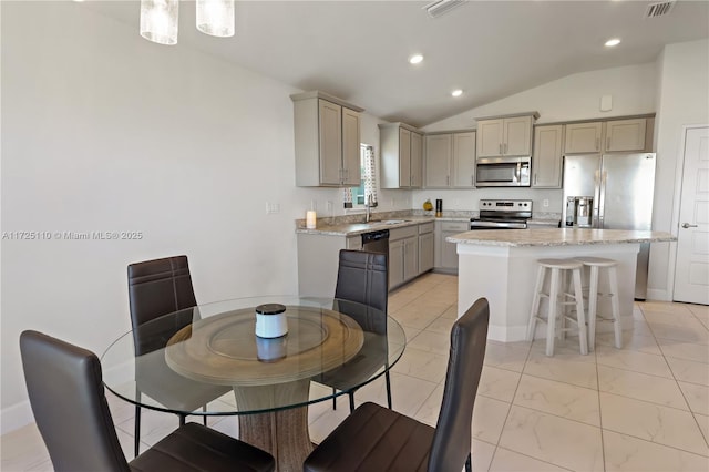 dining space with sink and vaulted ceiling