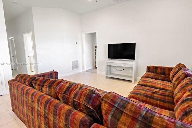 tiled living room with ceiling fan and high vaulted ceiling