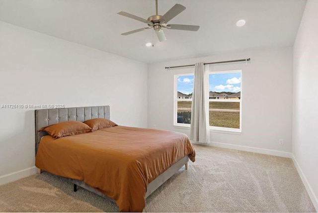 bedroom featuring ceiling fan and light colored carpet