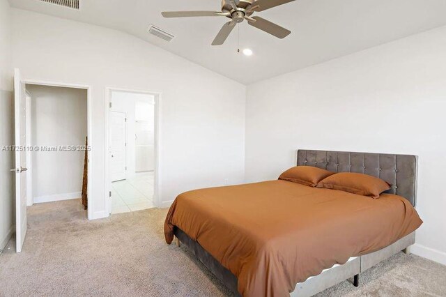 bedroom featuring light carpet, ceiling fan, and lofted ceiling