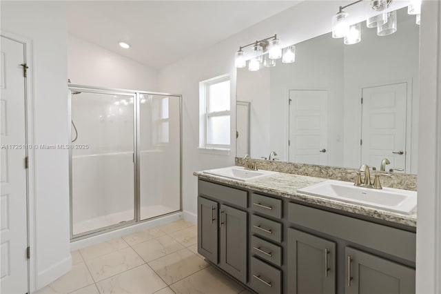 bathroom with vanity and a shower with shower door