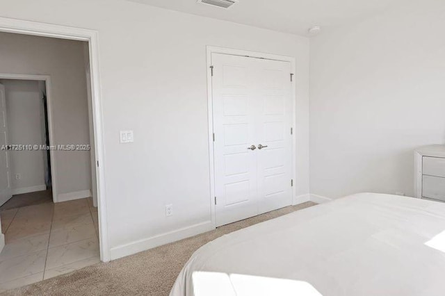 carpeted bedroom with a closet