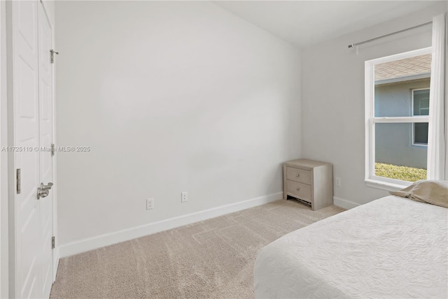 bedroom featuring light colored carpet