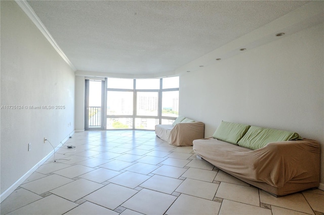 living room with crown molding, a textured ceiling, and a wall of windows