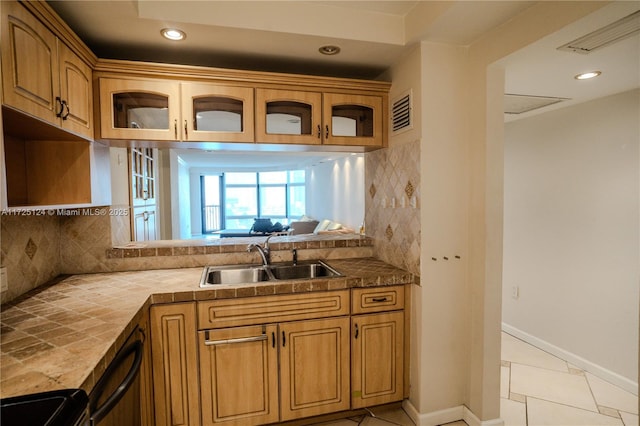 kitchen featuring sink, backsplash, range with electric cooktop, and light tile patterned floors