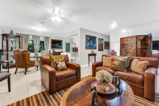 tiled living room featuring ceiling fan