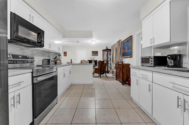 kitchen with kitchen peninsula, electric stove, tasteful backsplash, white cabinets, and light tile patterned flooring