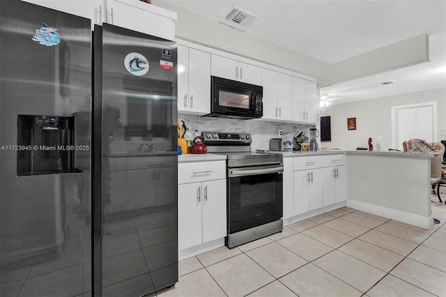 kitchen with light tile patterned flooring, white cabinetry, and appliances with stainless steel finishes