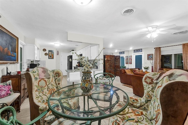 tiled living room featuring ceiling fan