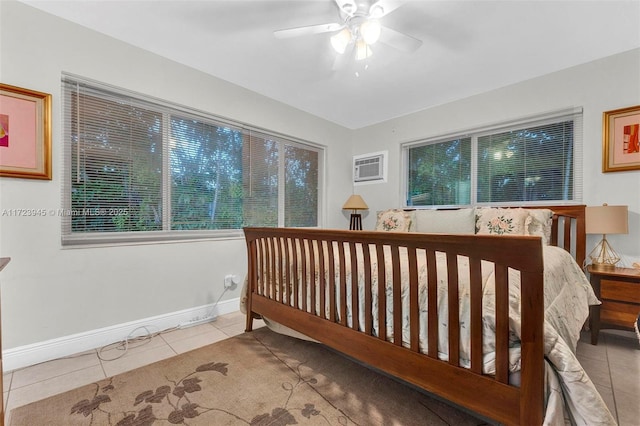 bedroom with an AC wall unit, ceiling fan, and light tile patterned floors