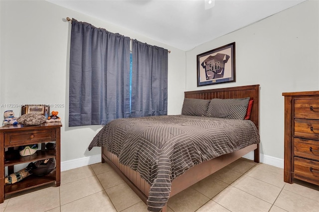 tiled bedroom featuring ceiling fan