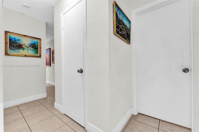 hall featuring light tile patterned floors