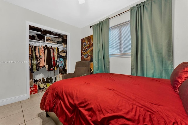 bedroom with light tile patterned flooring and a closet