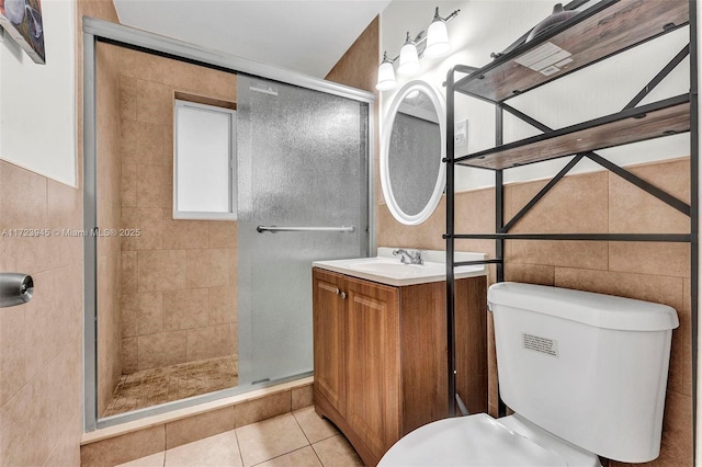 bathroom with toilet, tile patterned flooring, a shower with door, and vanity