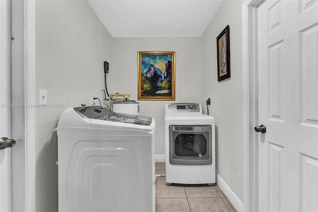 washroom featuring washer and dryer and light tile patterned floors